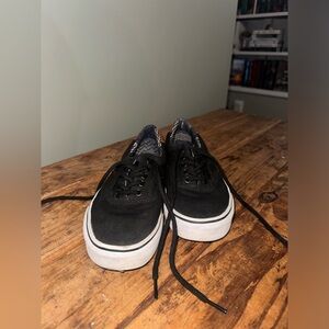 Black vans with tan accents. Slightly worn but still very good condition.